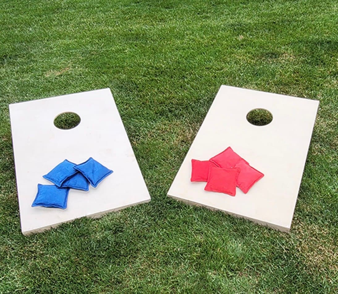 Cornhole boards set up on a lawn